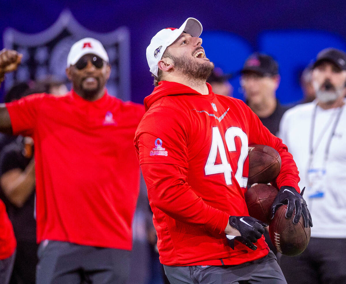 The AFC's Patrick Ricard (42) with the Ravens is pleased with his performance in a kickoff rece ...