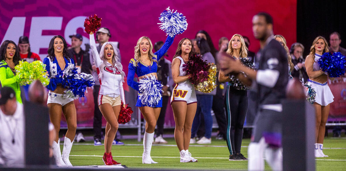 Cheerleaders show their support for the NFC's Geno Smith (7) of the Seahawks as he eyes a targe ...