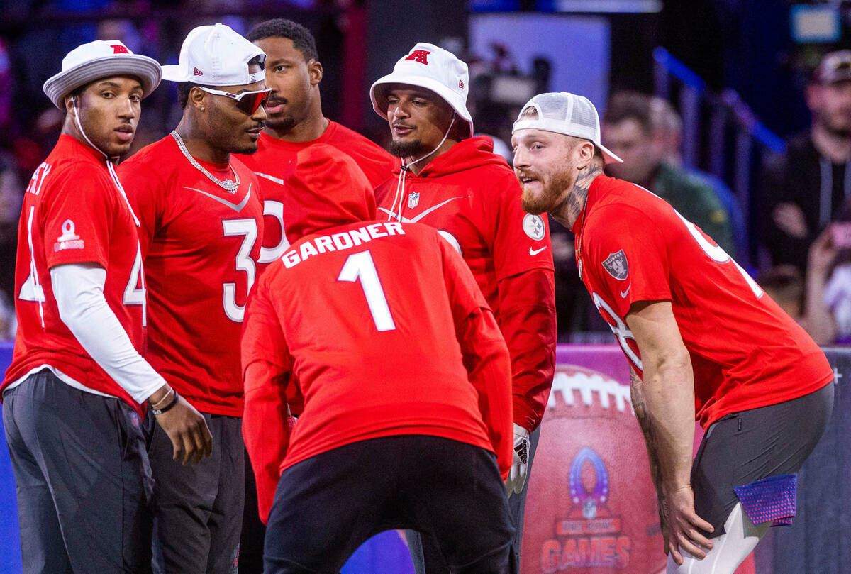 AFC teammates including the Max Crosby (98) of the Raiders huddle before a round of dodgeball d ...
