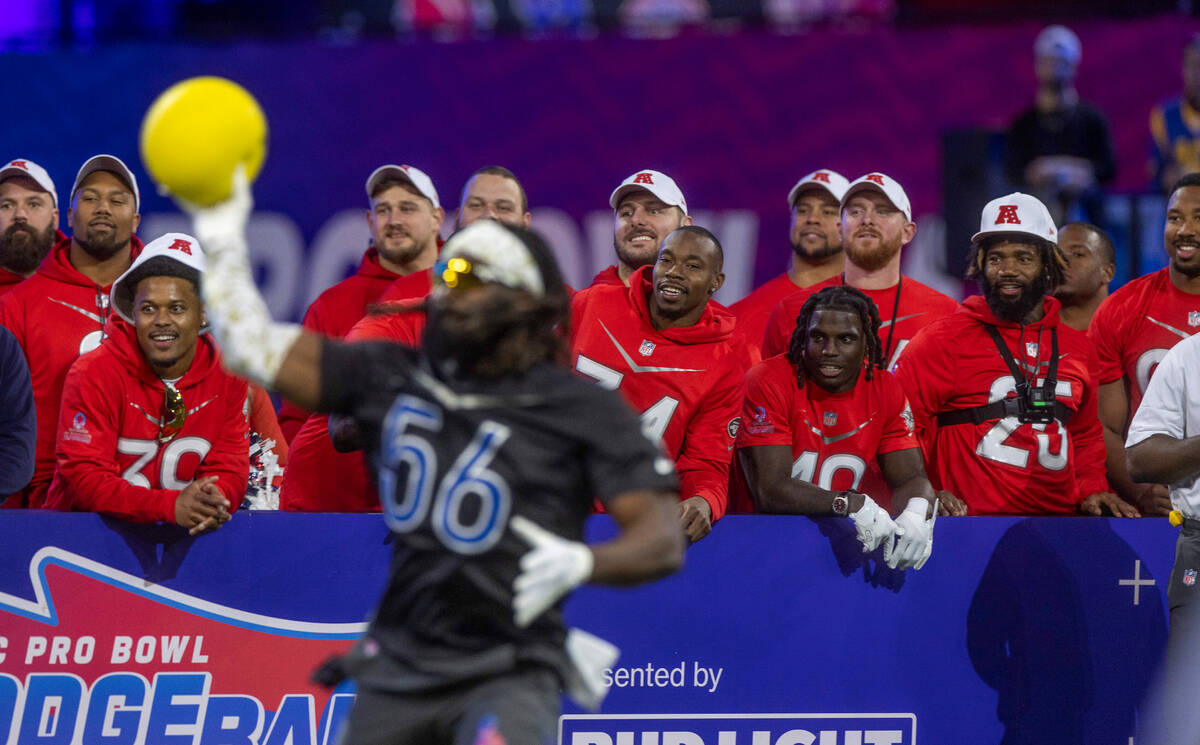 AFC teammates watch the action as the NFC's Demario Davis (56) of the Saints winds up for anoth ...