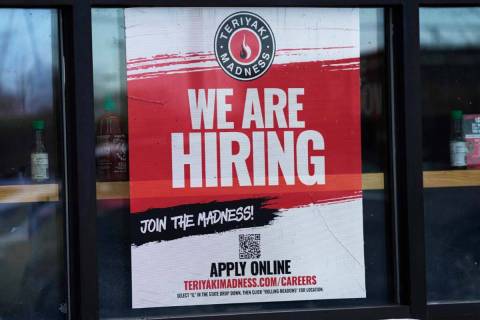 A hiring sign is displayed at a restaurant in Rolling Meadows, Ill., Monday, Jan. 30, 2023. Ame ...