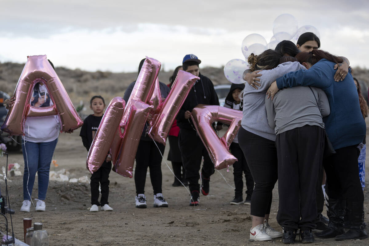 The family of Anna Scott, a member of the Pyramid Lake Paiute Tribe, embrace during a memorial ...