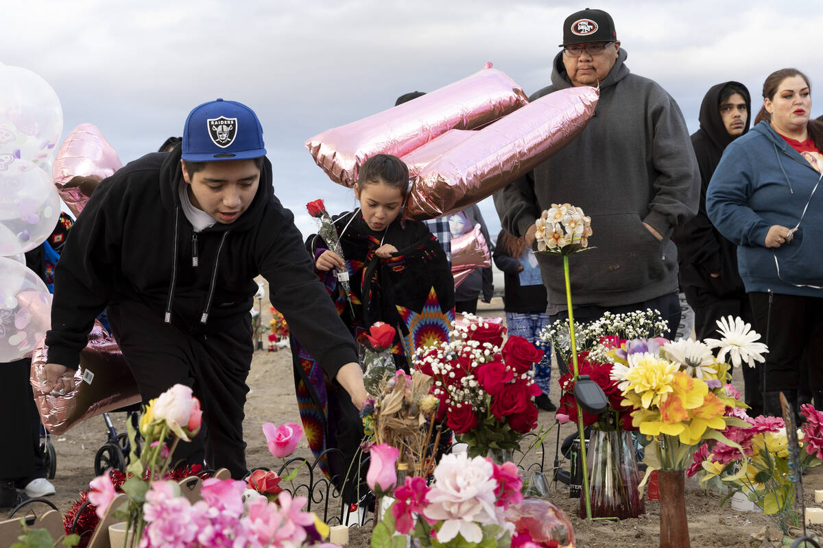 Loved ones of Anna Scott, a member of the Pyramid Lake Paiute Tribe, place flowers and mementos ...