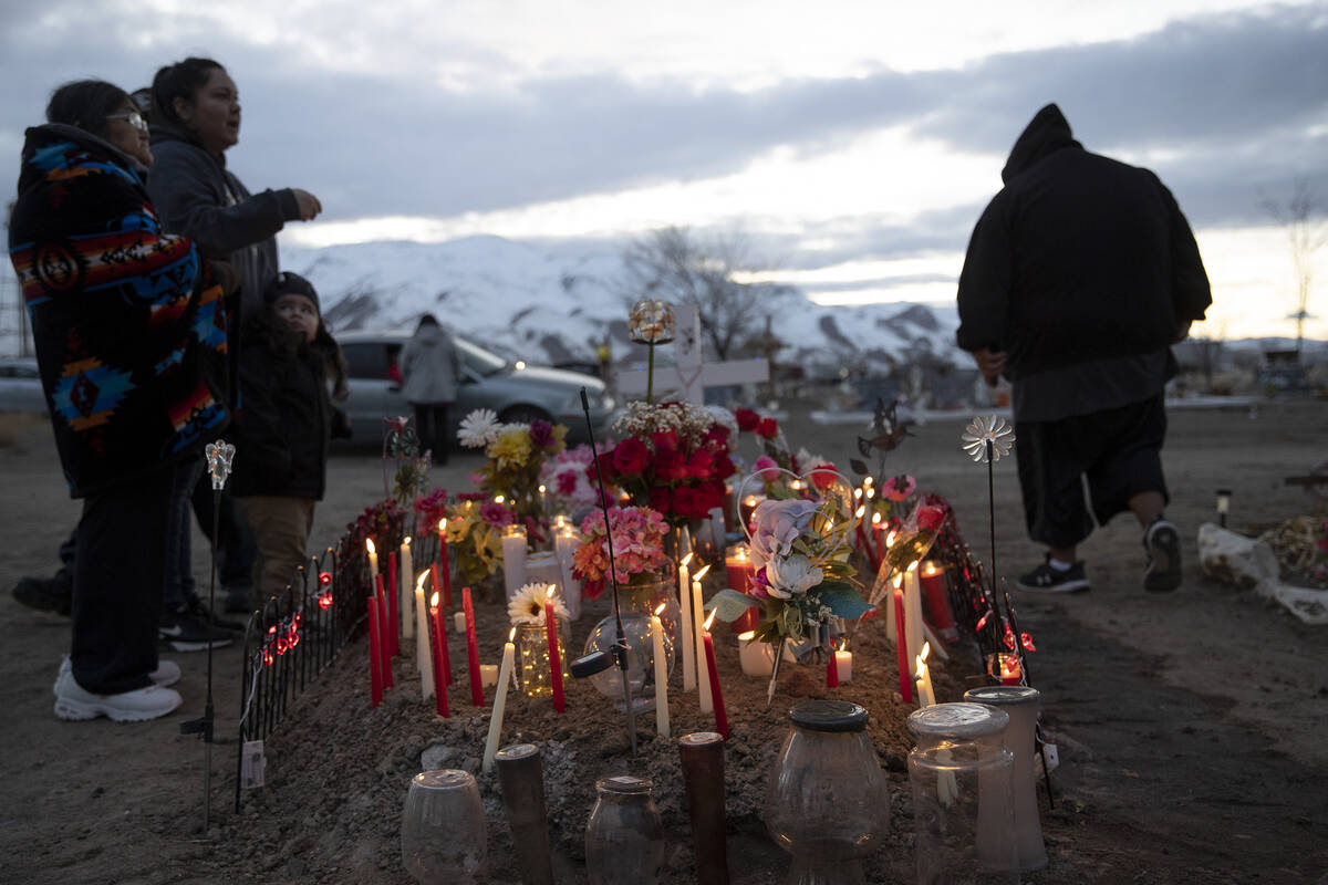 Loved ones of Anna Scott, a member of the Pyramid Lake Paiute Tribe, gather around her grave du ...