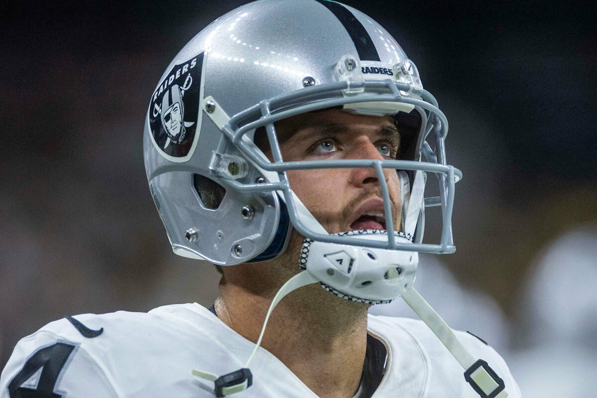 Raiders quarterback Derek Carr (4) watches the replay screen versus the New Orleans Saints duri ...