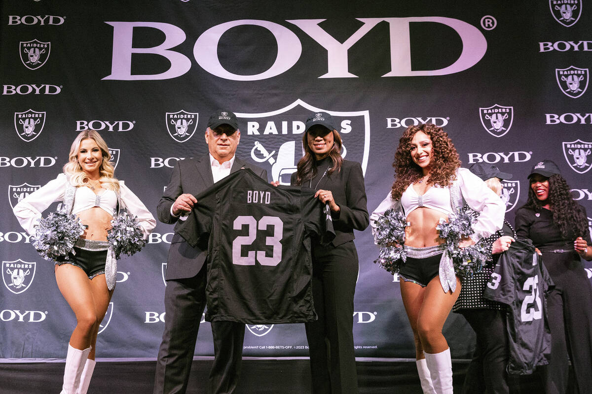 Keith Smith, second left, president and CEO of Boyd Gaming, and Raiders President Sandra Morgan ...