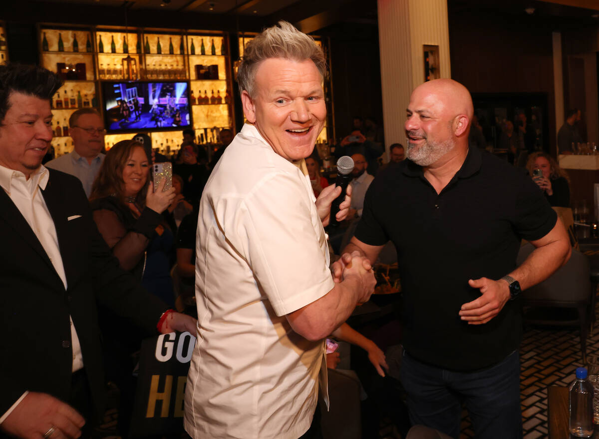 Chef Gordon Ramsay, left, greets 2 millionth guest, Khaled Aldada of Morgan Hill, Calif., at hi ...