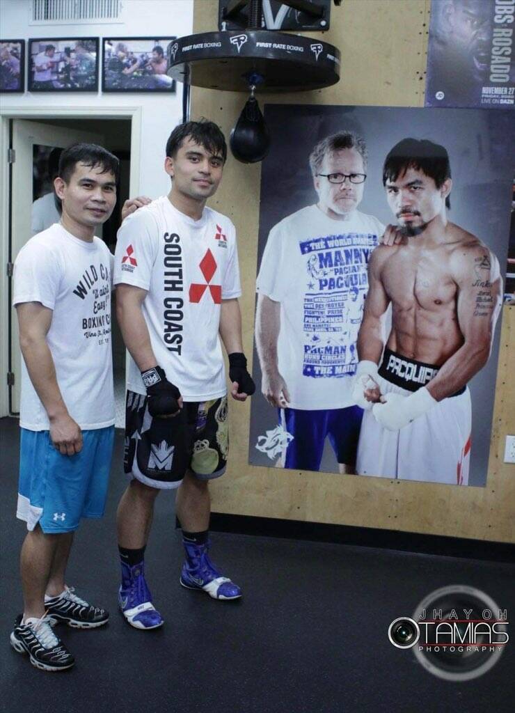 Emmanuel "Jimuel" Pacquiao Jr., second from left, and trainer Marvin Somodio stand next to a ph ...