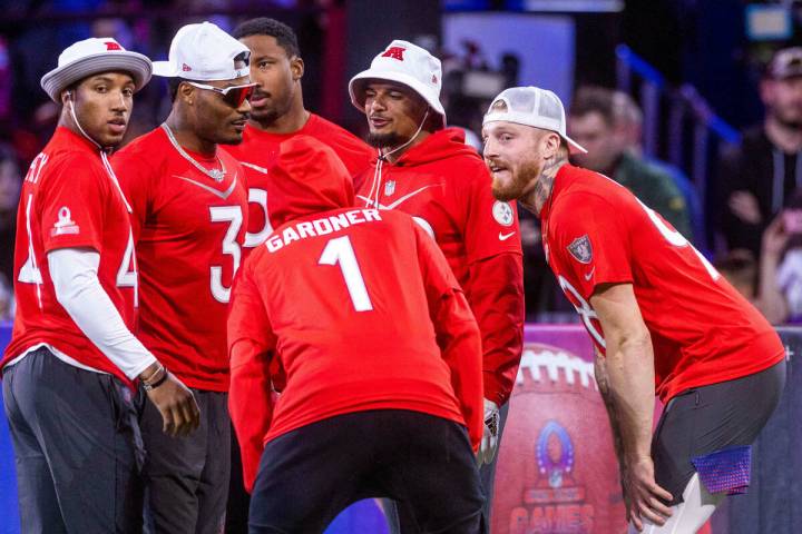 AFC teammates including the Max Crosby (98) of the Raiders huddle before a round of dodgeball d ...