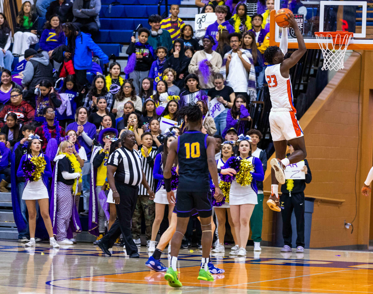 Bishop Gorman forward Christopher Nwuli (23) dunks the ball over Durango during the first half ...