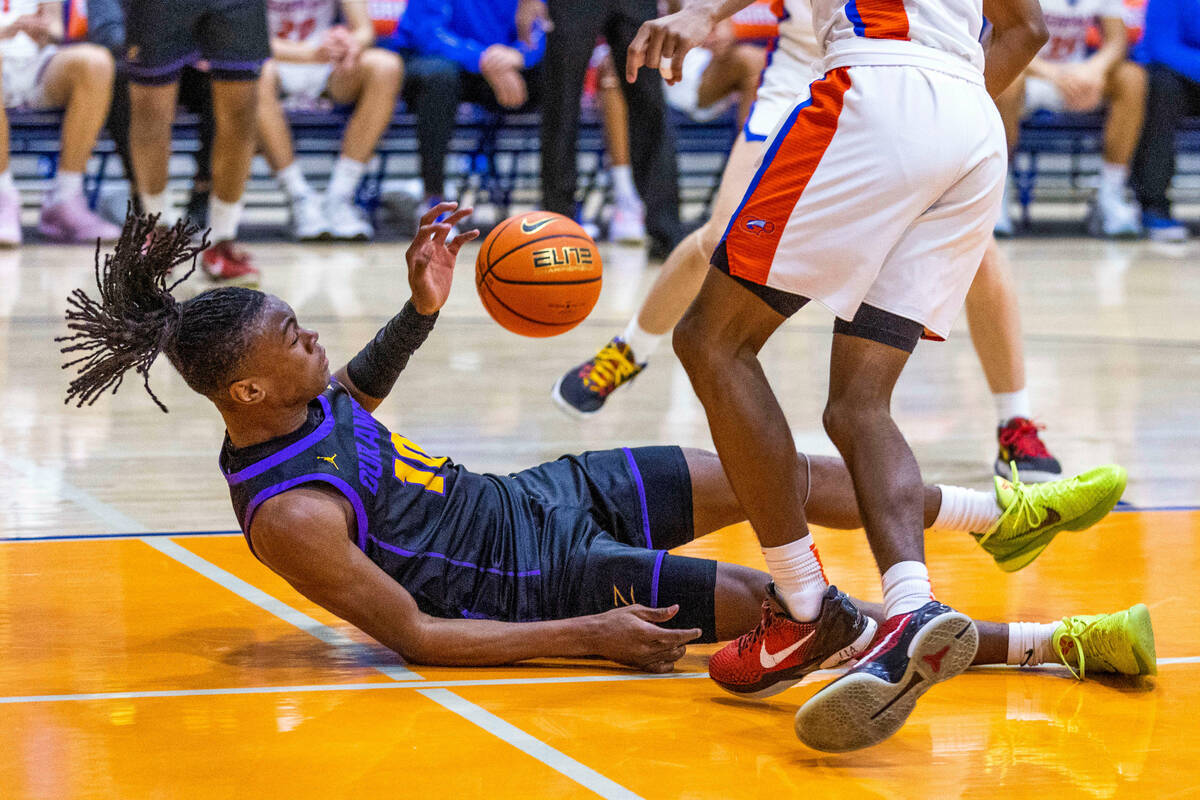 Durango guard Tylen Riley (10) is fouled hard by Bishop Gorman guard Nick Jefferson (10) on the ...