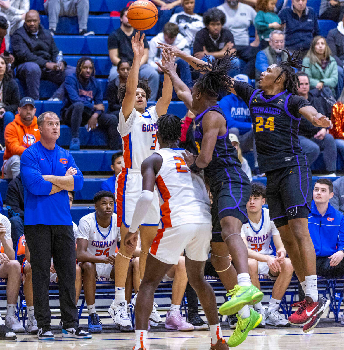 Bishop Gorman guard John Mobley Jr. (3) gets off a 3-point attempt over Durango guard Tylen Ril ...