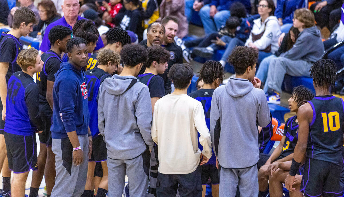 Durango assistant coach Mike Lee, center, and assistant coach Tim Jones counsel their players i ...