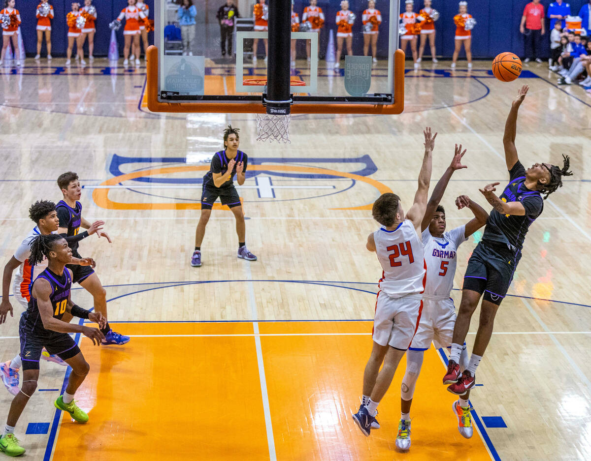 Durango guard Taj Degourville (24) shoots over Bishop Gorman guard Jaxon Richardson (5) and gua ...