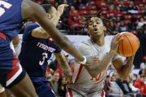 UNLV Rebels guard Keshon Gilbert (10) looks to pass against Fresno State Bulldogs guard Isaiah ...