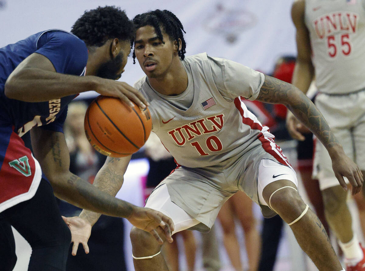 Fresno State Bulldogs guard Jordan Campbell (5) tries to drive past UNLV Rebels guard Keshon Gi ...