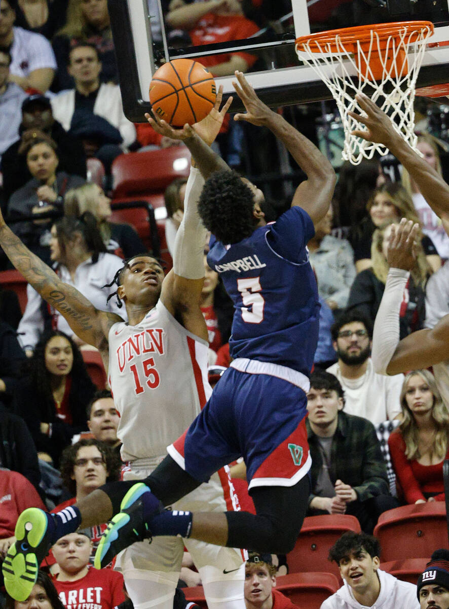 UNLV Rebels guard Luis Rodriguez (15) defends as Fresno State Bulldogs guard Jordan Campbell (5 ...