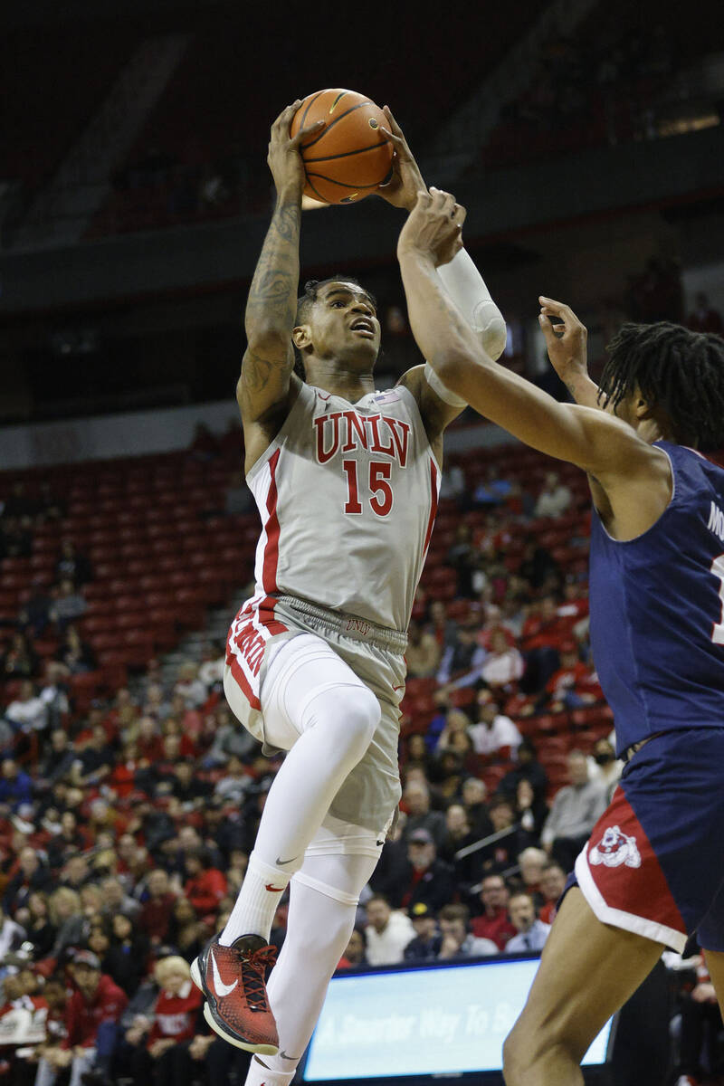 UNLV Rebels guard Luis Rodriguez (15) shoots over Fresno State Bulldogs forward Isaih Moore (11 ...