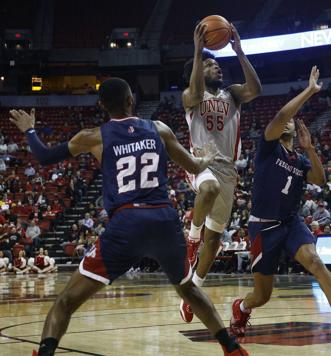 UNLV Rebels guard EJ Harkless (55) shoots over Fresno State Bulldogs guard Destin Whitaker (22) ...