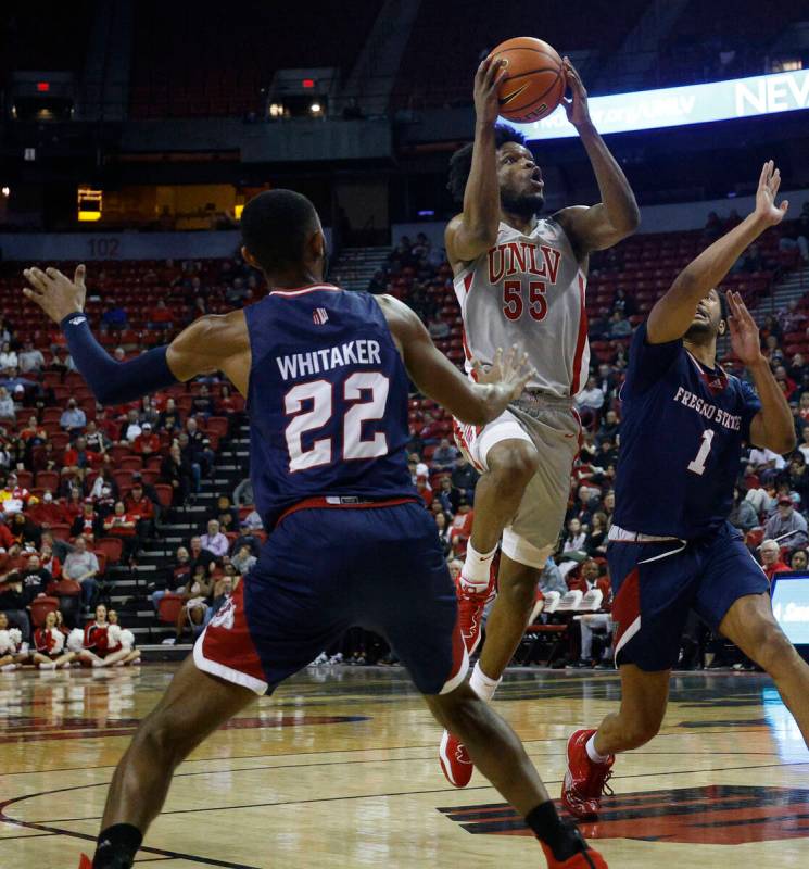 UNLV Rebels guard EJ Harkless (55) shoots over Fresno State Bulldogs guard Destin Whitaker (22) ...