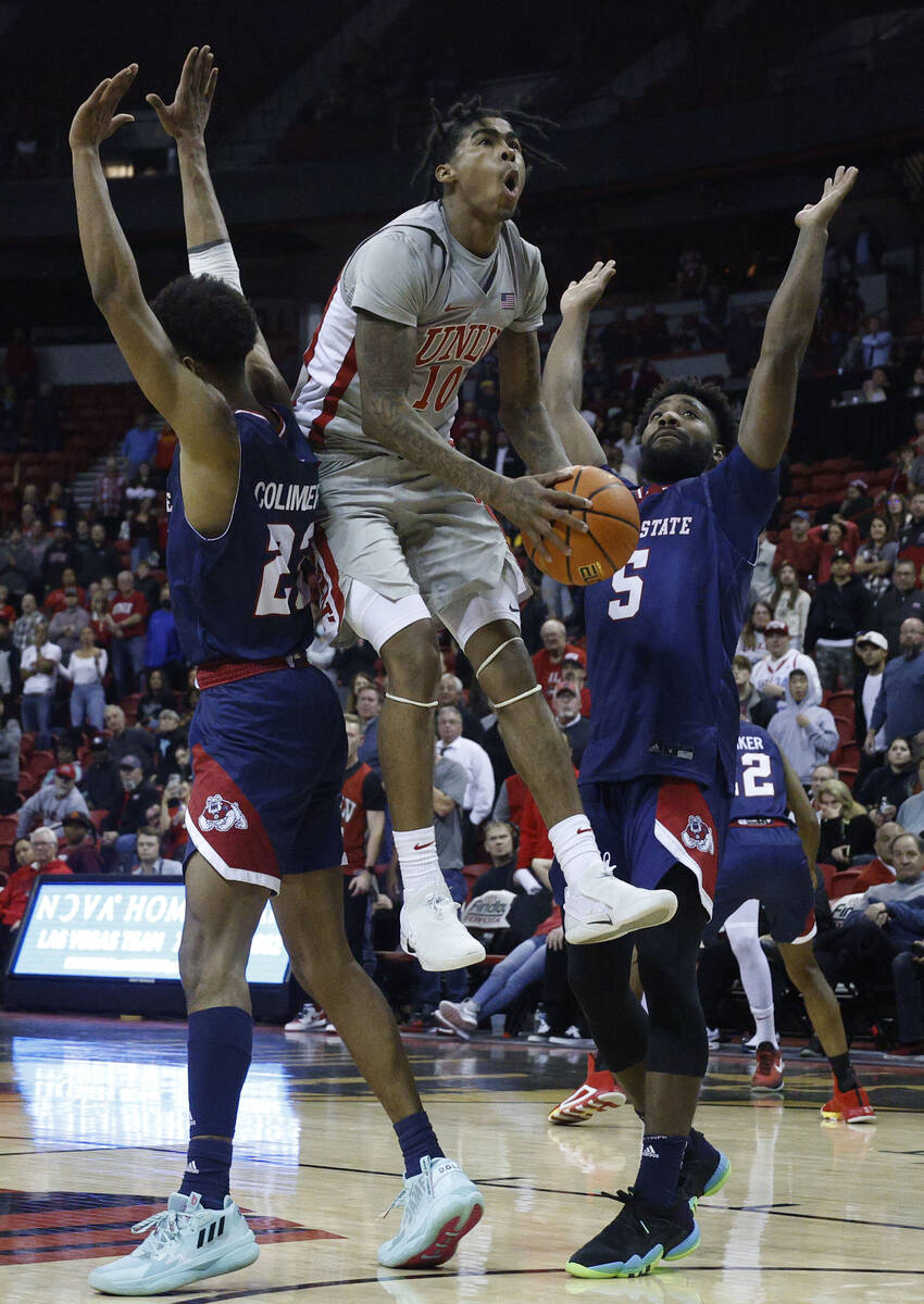 UNLV Rebels guard Keshon Gilbert (10) jumps to shoot as Fresno State Bulldogs guard Leo Colimer ...