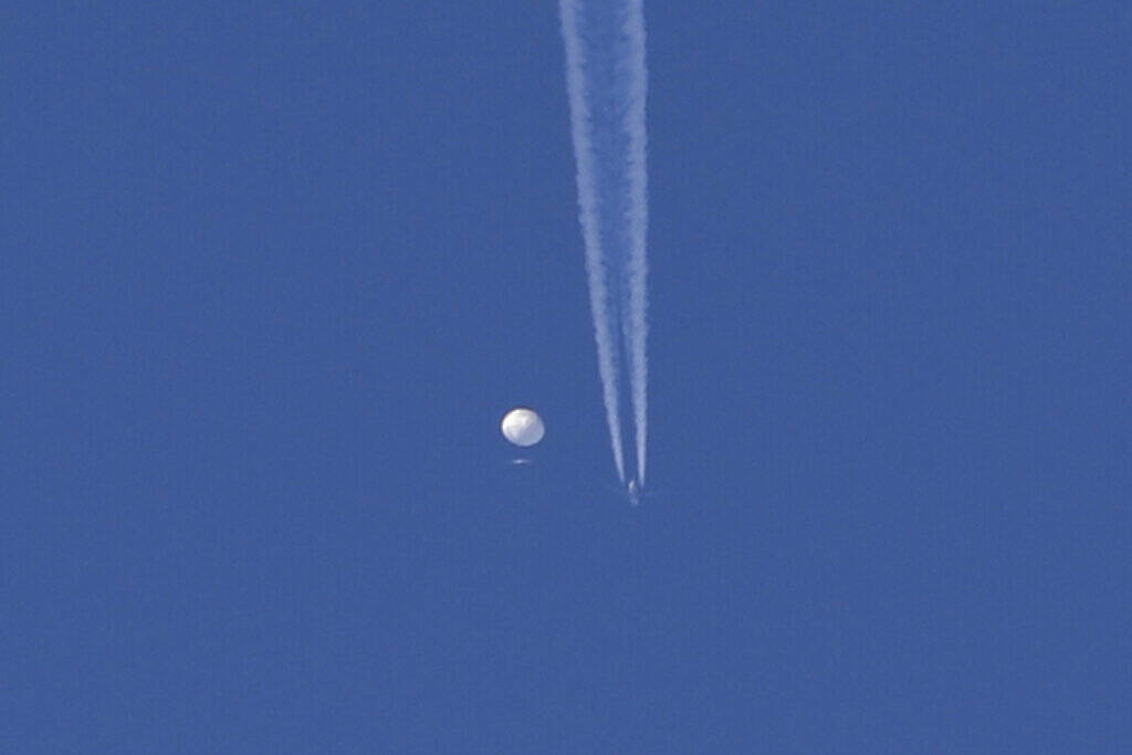 In this photo provided by Brian Branch, a large balloon drifts above the Kingstown, N.C. area, ...