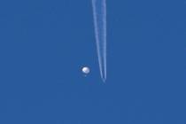 In this photo provided by Brian Branch, a large balloon drifts above the Kingstown, N.C. area, ...
