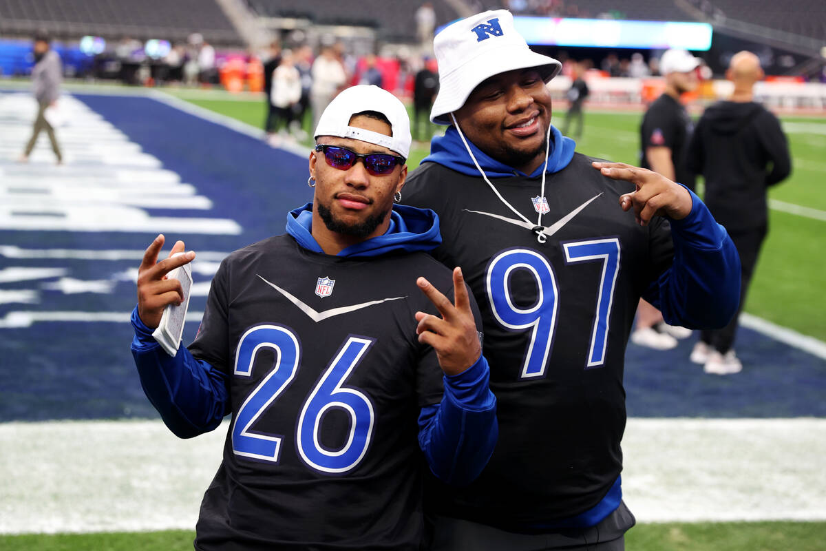 New York Giants' Saquon Barkley (26), left, and Dexter Lawrence (97), pose for a photo during a ...