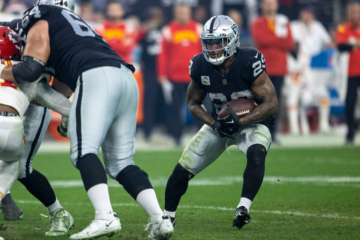 Raiders running back Josh Jacobs (28) looks for room to run against the Kansas City Chiefs duri ...