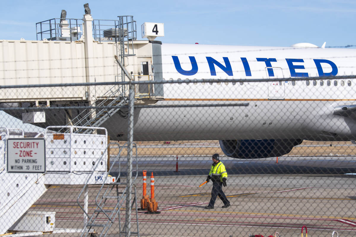 Members of the ground crew secure the site after a United airlines flight made an emergency lan ...