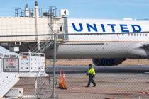 Members of the ground crew secure the site after a United airlines flight made an emergency lan ...