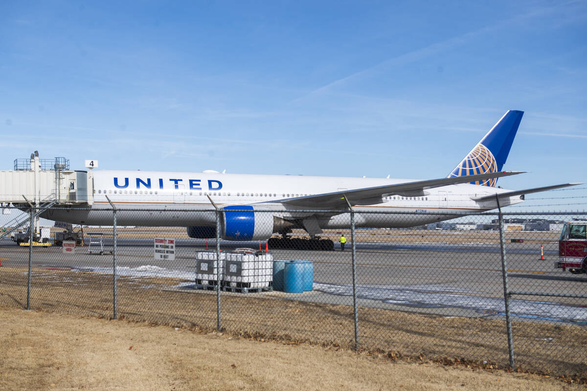 Emergency crews secure the site after a United airlines flight made an emergency landing at the ...