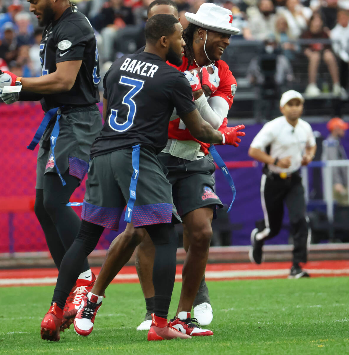 Las Vegas Raiders wide receiver Davante Adams (17) laughs after a play with Arizona Cardinals s ...