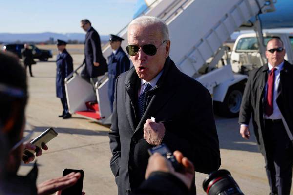 President Joe Biden speaks with members of the press after stepping off Air Force One at Hagers ...