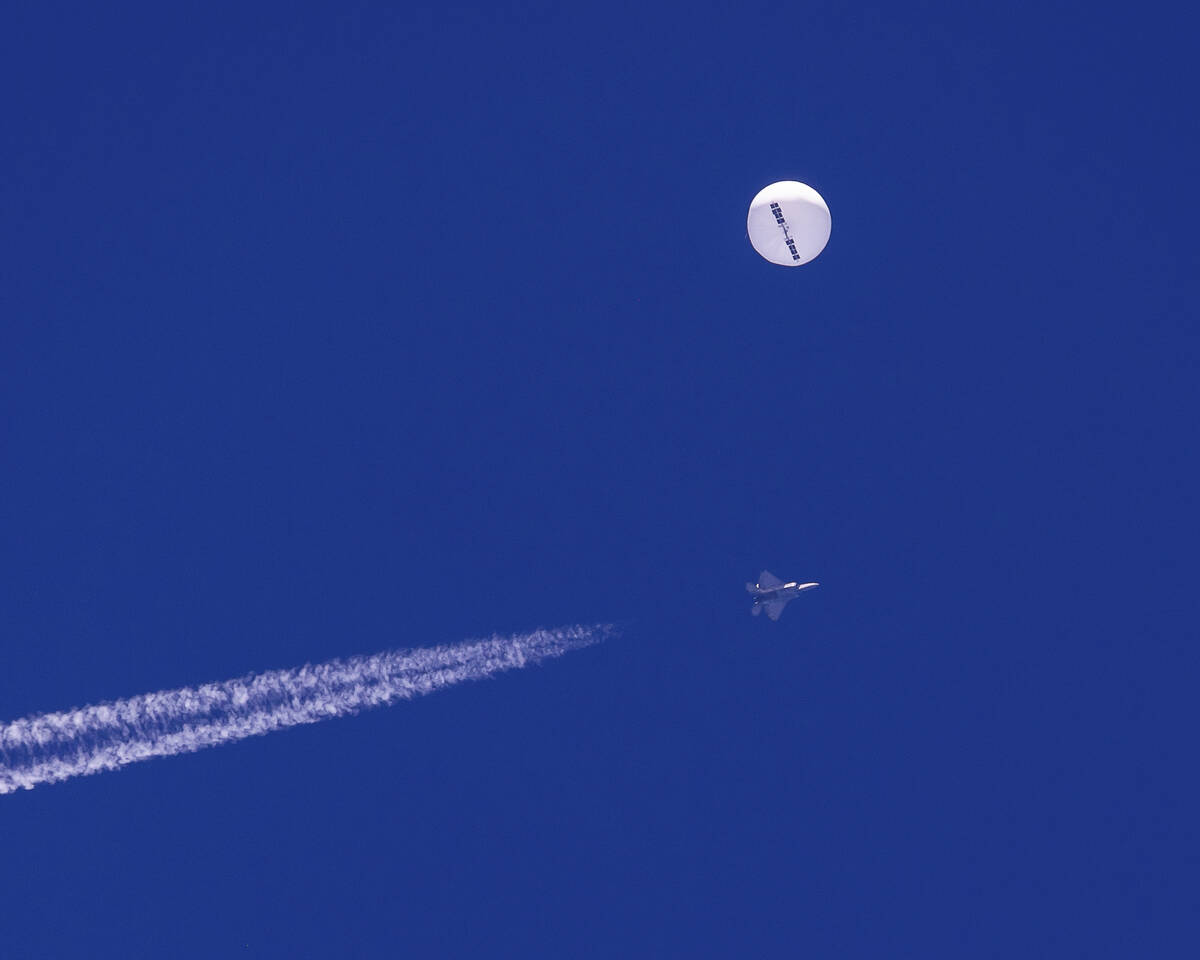 In this photo provided by Chad Fish, a large balloon drifts above the Atlantic Ocean, just off ...