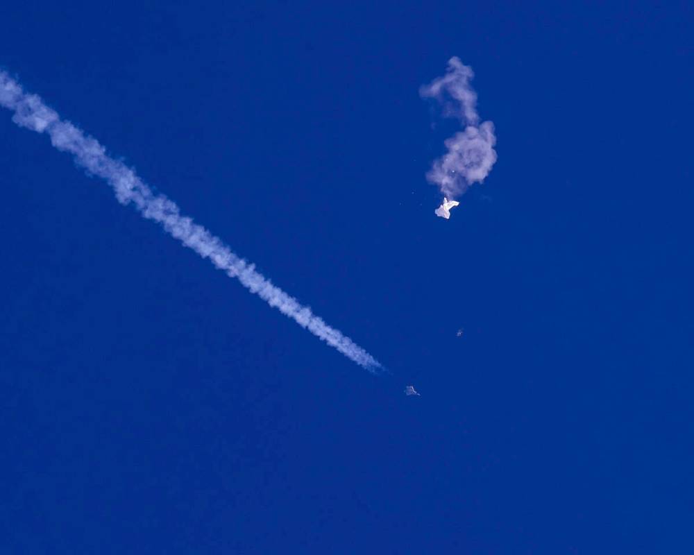 In this photo provided by Chad Fish, the remnants of a large balloon drift above the Atlantic O ...