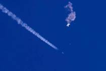 In this photo provided by Chad Fish, the remnants of a large balloon drift above the Atlantic O ...