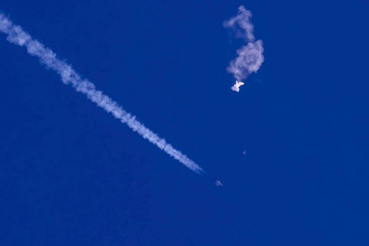 In this photo provided by Chad Fish, the remnants of a large balloon drift above the Atlantic O ...