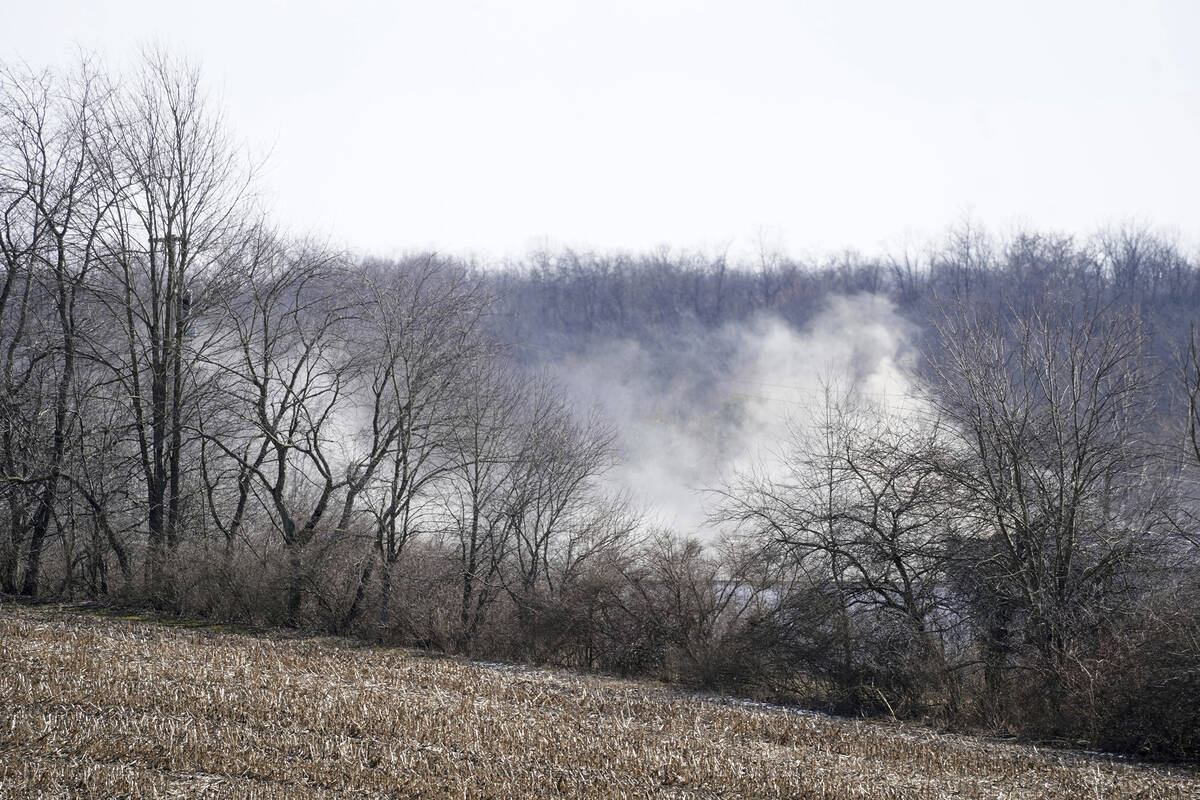 Smoke still billows from the remains of the train derailment in East Palestine, Ohio, on Sunday ...
