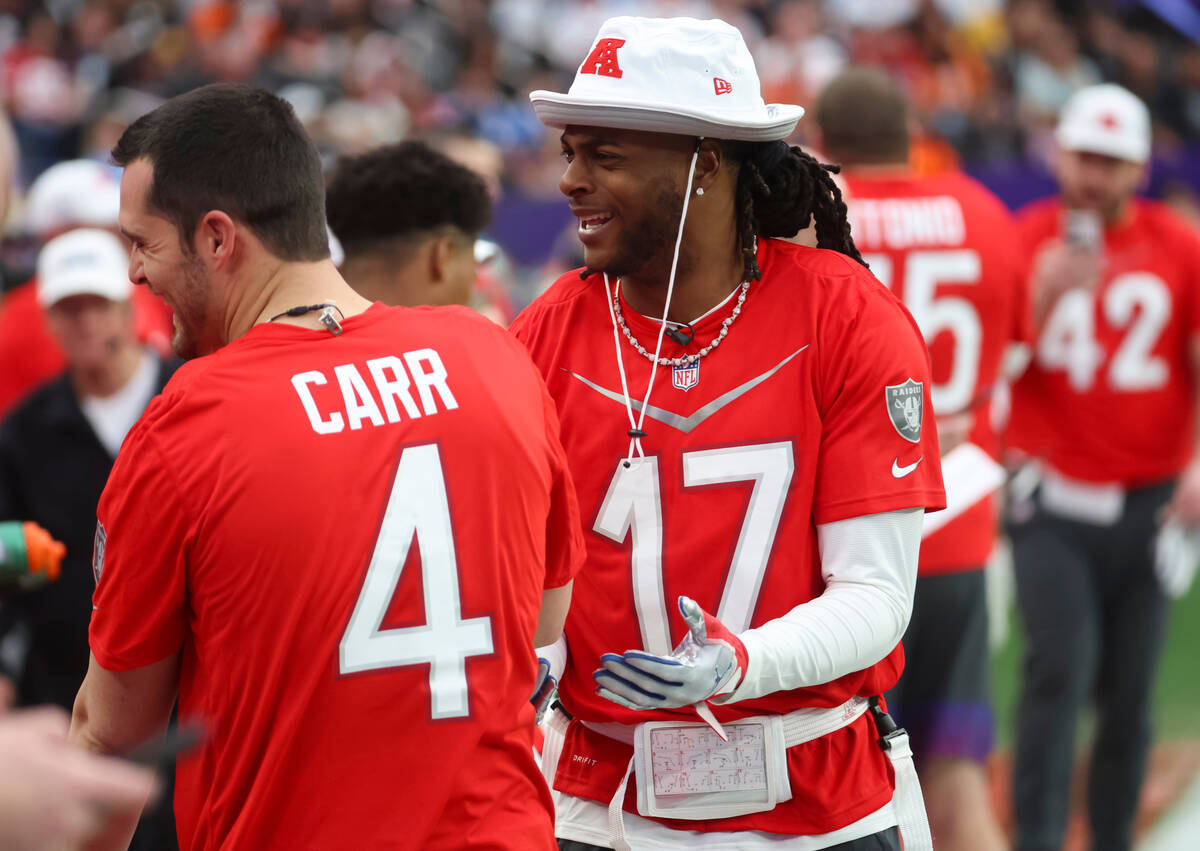 Las Vegas Raiders wide receiver Davante Adams (17) shares a laugh with Las Vegas Raiders quarte ...