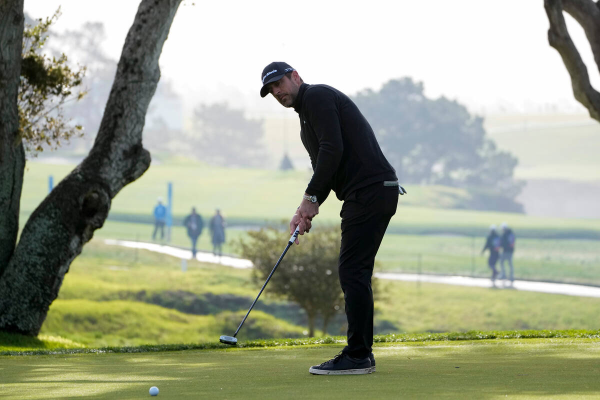 Aaron Rodgers follows his putt on the 16th green of the Pebble Beach Golf Links during the thir ...