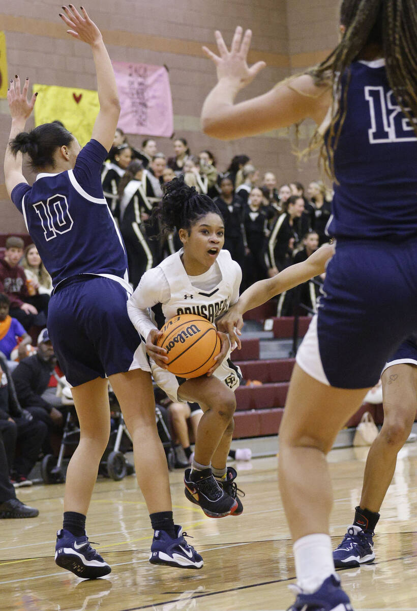 Faith Lutheran's Tamiah Harrison (4) tries to drive past Centennial's Tayla Perkins (10) and Ce ...