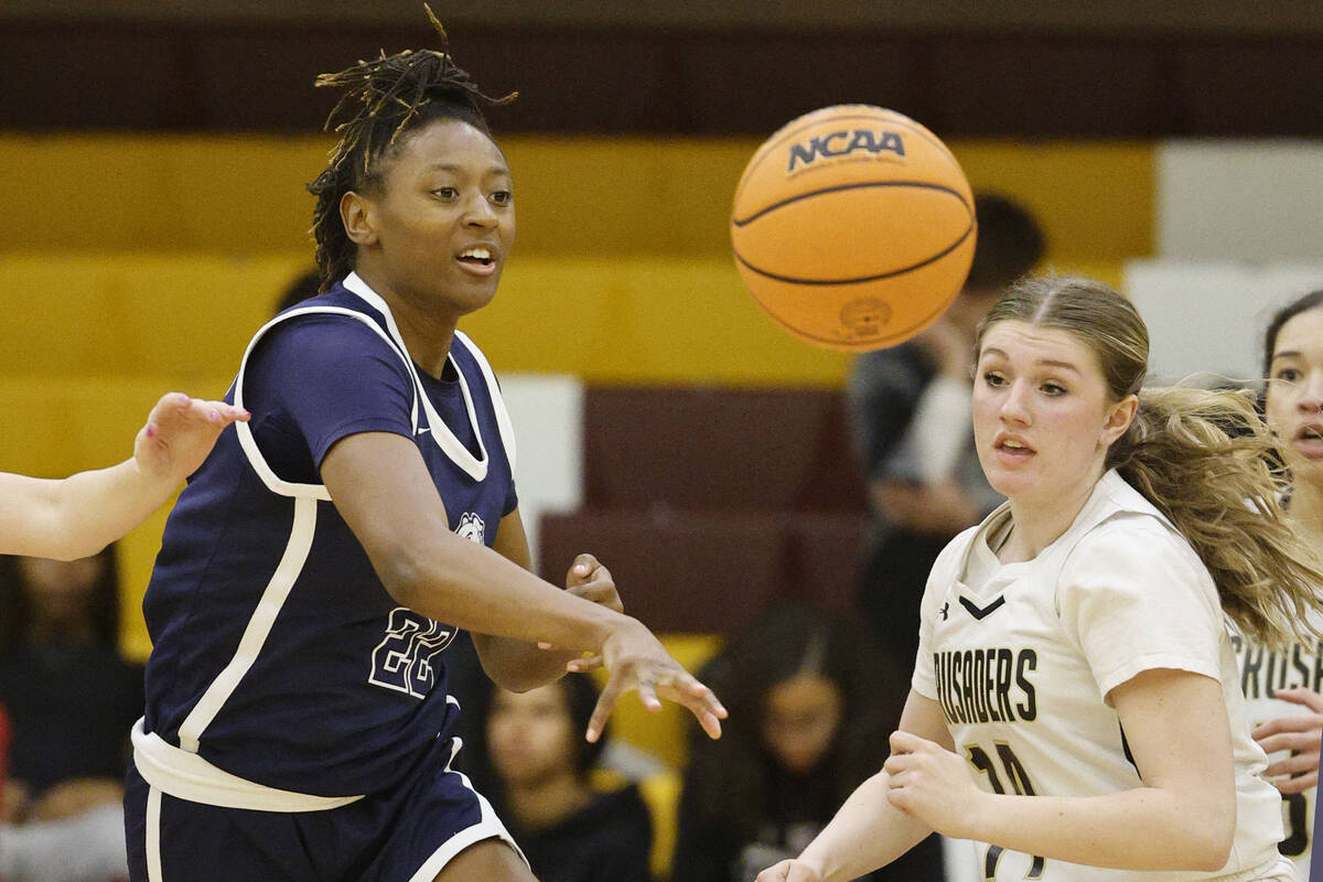 Centennial's Kaliyah Dillard (22) passes a ball as Faith Lutheran's Gillian Norton (14) looks o ...