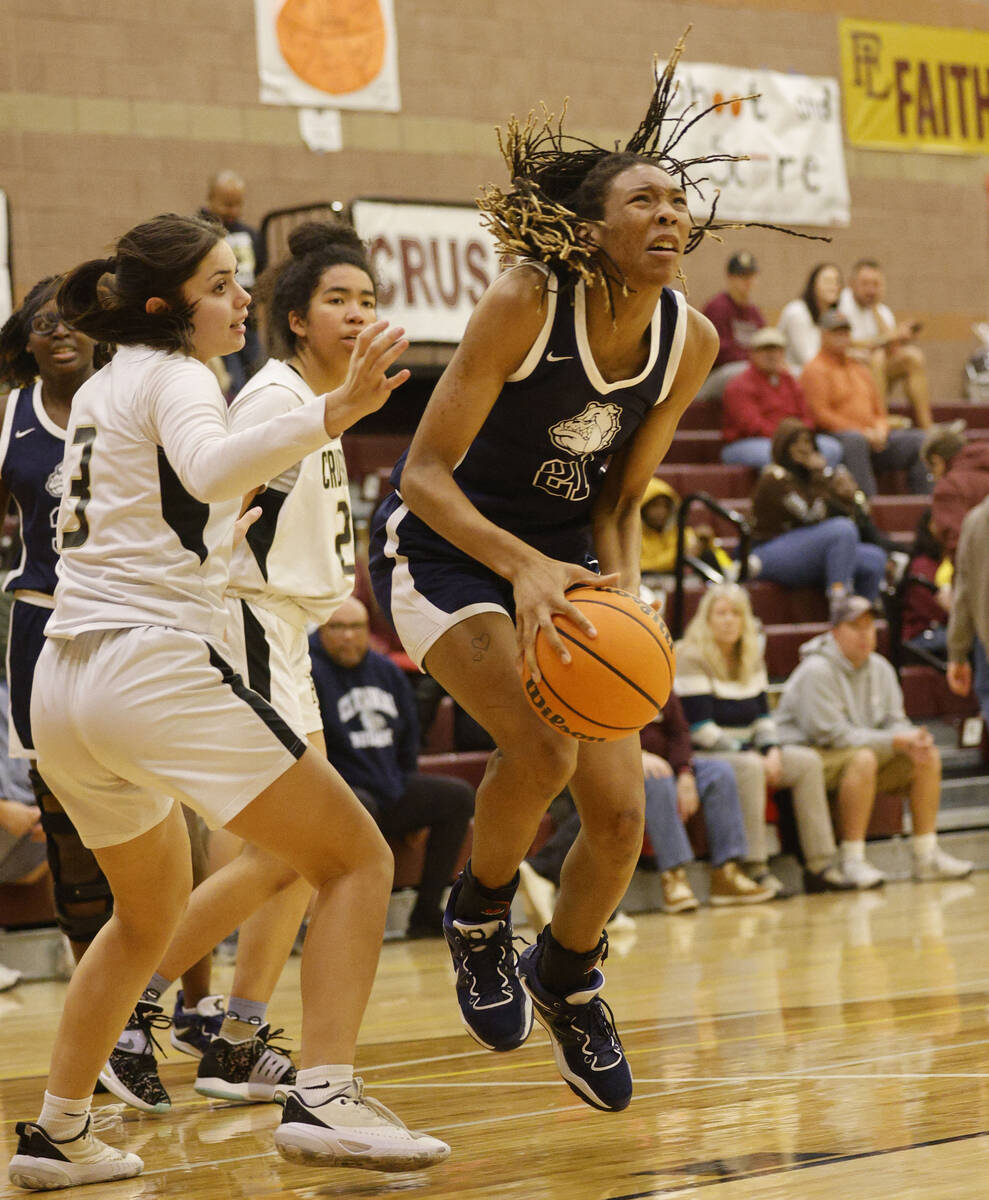 Centennial's Cici Ajomale (21) jumps to shoot as Faith Lutheran's Gabby Libonati (3), left, loo ...