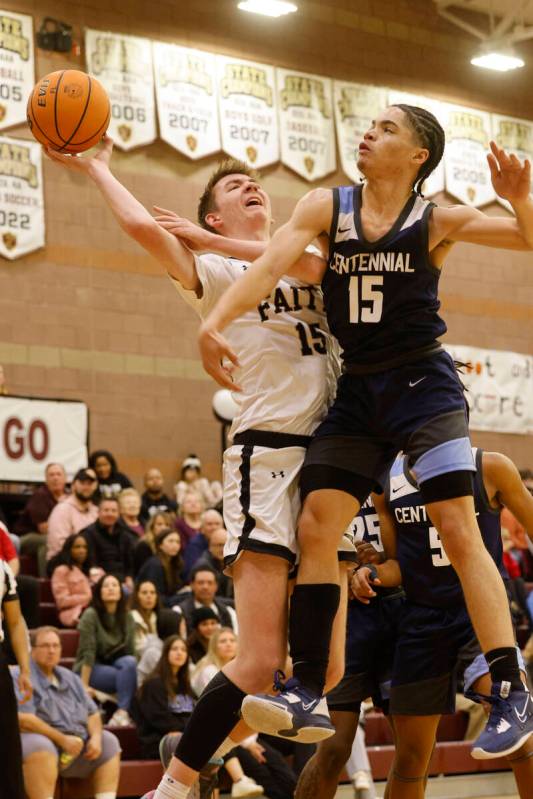 Faith Lutheran's Graydon Lemke (15) tries to shoot the ball as Centennial's Elijah Burney (15) ...