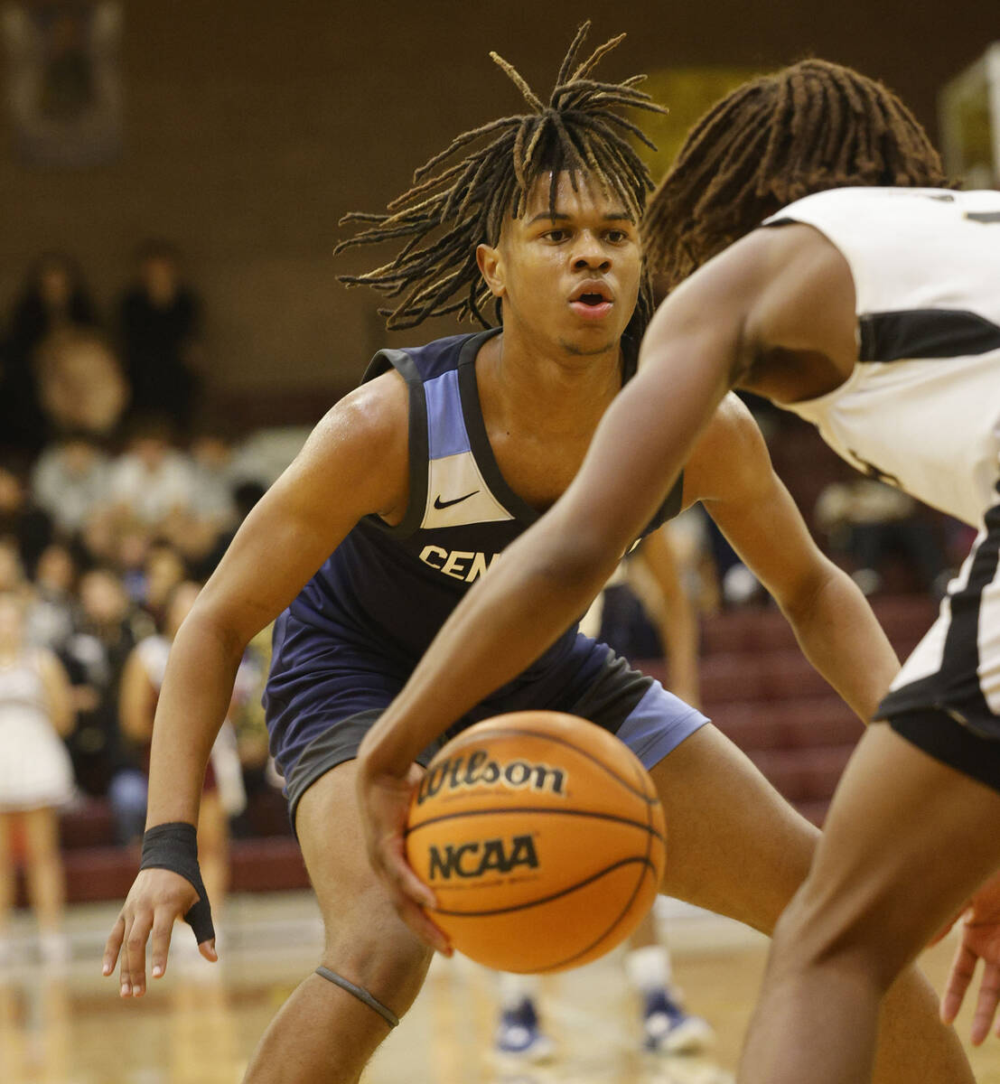 Faith Lutheran's Johnpaul Agu, right, tries to drive past Centennial's RJ Nance (5), face to ca ...