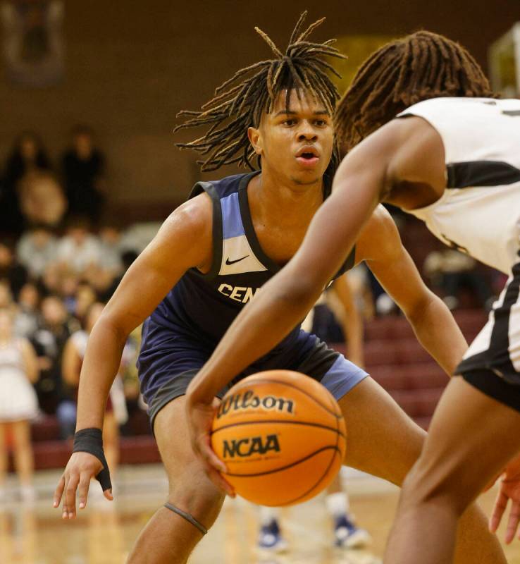 Faith Lutheran's Johnpaul Agu, right, tries to drive past Centennial's RJ Nance (5), face to ca ...