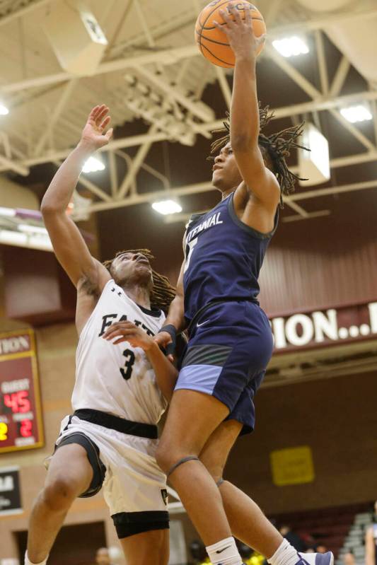 Centennial's RJ Nance (5) shoots over Faith Lutheran's Johnpaul Agu (3) during the second half ...