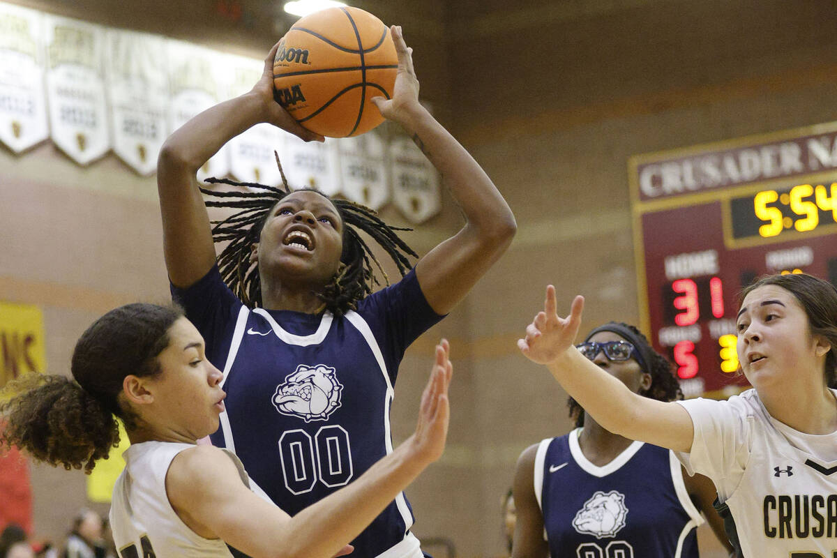 Centennial's Kaniya Boyd (00) shoots the ball as Faith Lutheran's Leah Mitchell (34) and Faith ...