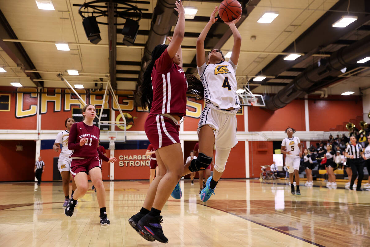 Clark's Anaya Williams (4) goes up for a shot under pressure from Desert Oasis' Jordyn Figueroa ...